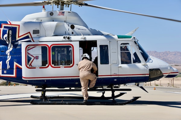 An air medical evacuation helicopter touches down on the helipad at Naval Hospital Twentynine Palms during the Semper Durus 2025 regional training exercise, May 21. As part of the simulated mass casualty scenario—staged in coordination with Marine Corps Air Ground Combat Center (MCAGCC) and other base tenants—the aircraft transported two role-playing Marines with critical injuries sustained in a notional explosion and friendly fire incident on Range 112. Emergency Department personnel awaited the inbound casualties, activating the hospital’s Mass Casualty Protocol and preparing to receive, triage, and stabilize patients as part of the hospital’s comprehensive response. The exercise tested the hospital’s ability to coordinate with partner agencies under pressure and underscored the importance of rapid decision-making, interagency communication, and real-world readiness (U.S. Navy photo by Christopher C. Jones, NHTP/NMRTC Twentynine Palms public affairs officer).