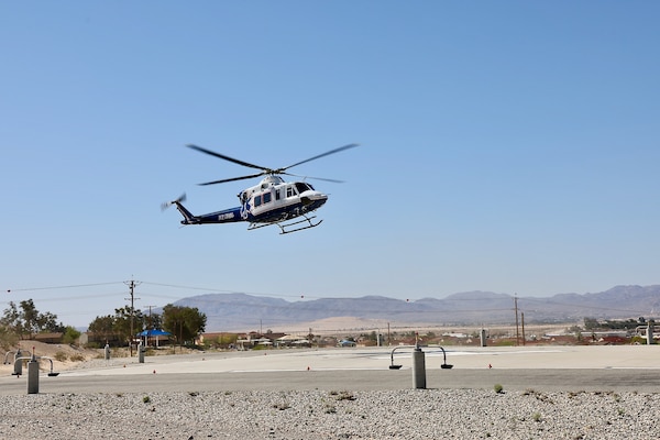 An air medical evacuation helicopter touches down on the helipad at Naval Hospital Twentynine Palms during the Semper Durus 2025 regional training exercise, May 21. As part of the simulated mass casualty scenario—staged in coordination with Marine Corps Air Ground Combat Center (MCAGCC) and other base tenants—the aircraft transported two role-playing Marines with critical injuries sustained in a notional explosion and friendly fire incident on Range 112. Emergency Department personnel awaited the inbound casualties, activating the hospital’s Mass Casualty Protocol and preparing to receive, triage, and stabilize patients as part of the hospital’s comprehensive response. The exercise tested the hospital’s ability to coordinate with partner agencies under pressure and underscored the importance of rapid decision-making, interagency communication, and real-world readiness (U.S. Navy photo by Christopher C. Jones, NHTP/NMRTC Twentynine Palms public affairs officer).