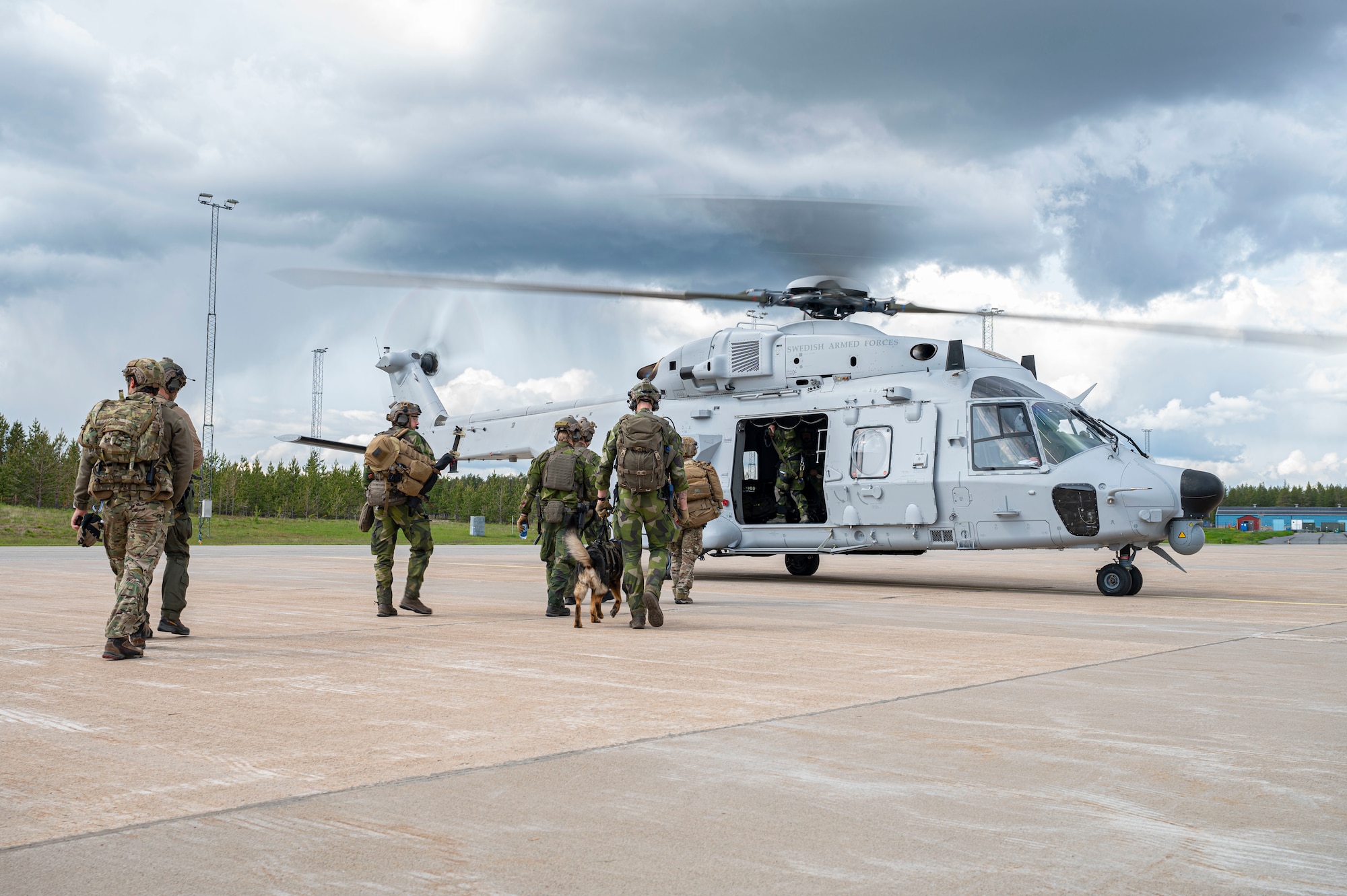 people standing outside helicopter