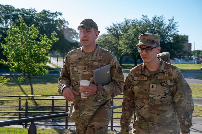 Members of the 403rd Wing Religious Affairs Office walk toward the Roberts Maintenance Facility.