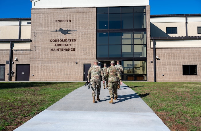 Members of the 403rd Wing Religious Affairs Office walk toward the Roberts Maintenance Facility.