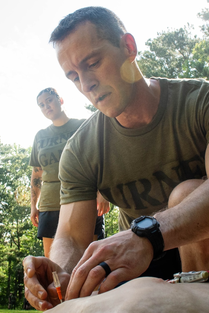 *Training* Lieutenant Commander Jacob Wittenauer, right, performs a chest decompression on a training manikin during the Corpsman Cup held Friday, June 13 aboard Marine Corps Air Station Cherry Point.  The event tested the Corpsmen’s’ tactical medical skills, mental resilience and physical fitness through various stations.  Wittenauer serves aboard Naval Health Clinic Cherry Point.