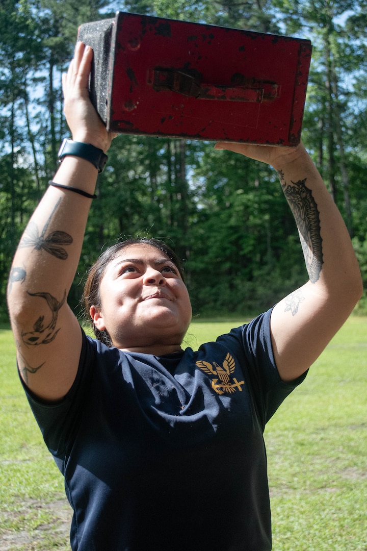 Hospitalman Gabriella Tellez, a Sailor assigned to Naval Heath Clinic Cherry Point, conducts ammo-can lifts as part of the Corpsman Cup held Friday, June 13 aboard Marine Corps Air Station Cherry Point.  The event tested the Corpsmen’s’ tactical medical skills, mental resilience and physical fitness through various stations.