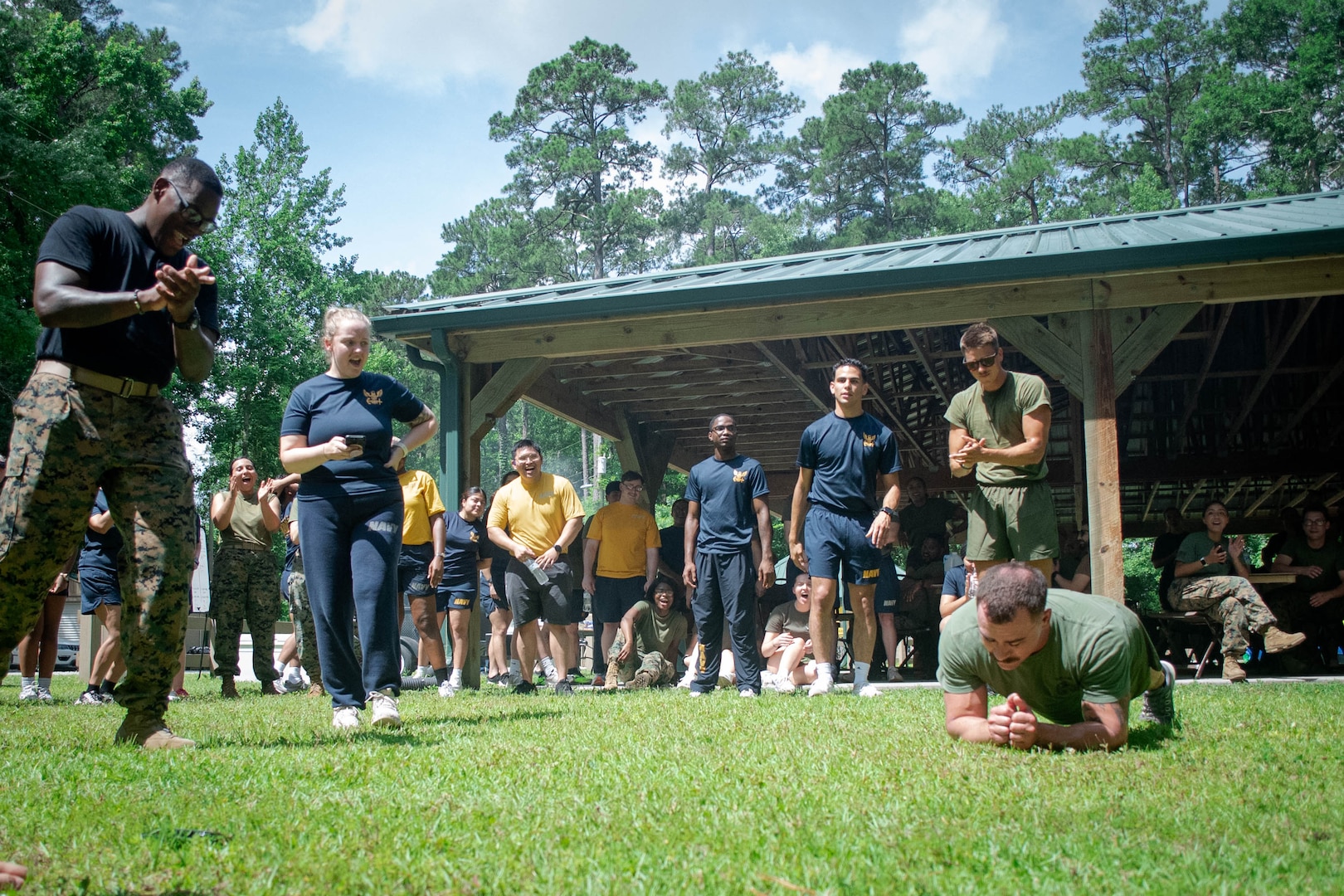 Sailors cheer as Hospital Corpsman Second Class Jon Cericola, a Sailor assigned to 2nd Marine Aircraft Wing’s Warrior Wellness and Readiness Clinic wins a tie-breaker plank event with a total time of five minutes, fifty-one seconds, to win the Corpsman Cup for his team.  The Corpsman Cup, held Friday, June 13 aboard Marine Corps Air Station Cherry Point, tested the Sailors tactical medical skills, mental resilience and physical fitness through various stations.