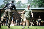 Hospital Corpsman Second Class Jon Cericola, a Sailor assigned to 2nd Marine Aircraft Wing’s Warrior Wellness and Readiness Clinic receives congratulations for holding a plank for five minutes, fifty-one seconds to win the Corpsman Cup for his team during a tie-breaker event.  The Corpsman Cup, held Friday, June 13 aboard Marine Corps Air Station Cherry Point, tested the Sailors tactical medical skills, mental resilience and physical fitness through various stations.