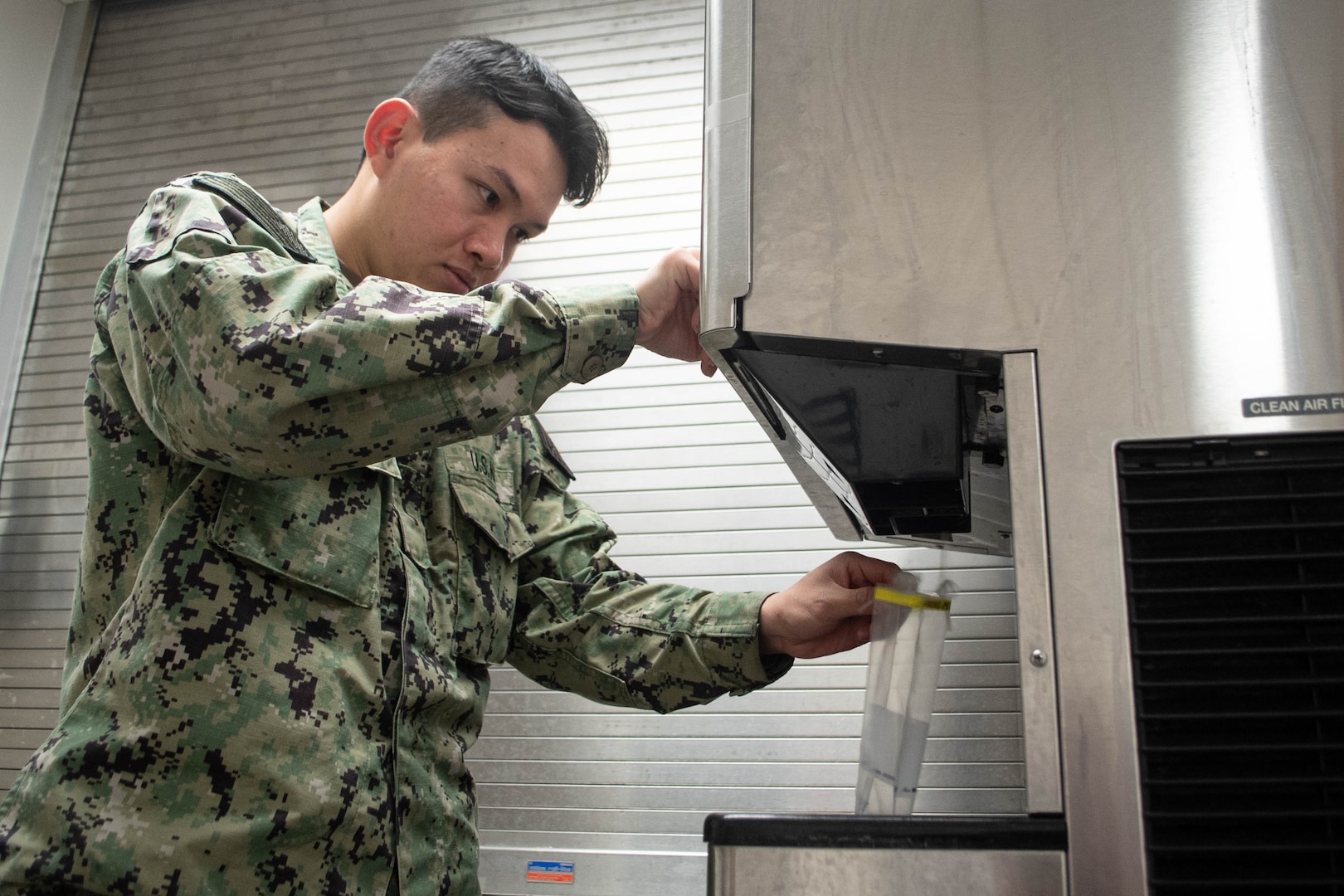 Hospitalman An Tran obtains a water sample from an ice machine Thursday, June 12, 2025, at Naval Health Clinic Cherry Point.  Assigned to the clinic’s Preventive Medicine Department, Tran helps protect the base’s staff, residents and service members from disease.