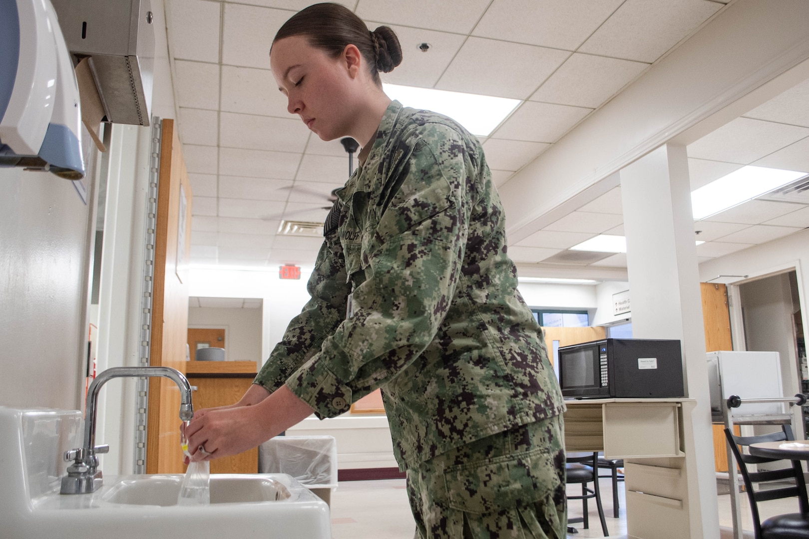 Hospital Corpsman Third Class Nikki Brown Wolff obtains a water sample Thursday, June 12, 2025, at Naval Health Clinic Cherry Point.  Assigned to the clinic’s Preventive Medicine Department, the Las Vegas, Nevada native helps protect the base’s staff, residents and service members from disease.