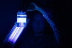 Hospital Corpsman Third Class Nikki Brown Wolff uses an ultraviolet light to inspect a water sample taken at Marine Corps Air Station Cherry Point on Tuesday, June 17.  Brown Wolff, a native of Las Vegas, Nevada, serves in the Preventive Medicine Department aboard Naval Health Clinic Cherry Point, helping protect the base’s staff, residents and service members from disease.