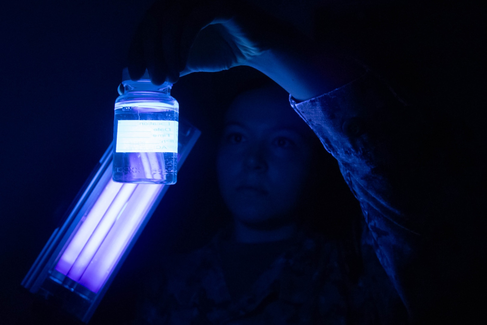 Hospital Corpsman Third Class Nikki Brown Wolff uses an ultraviolet light to inspect a water sample taken at Marine Corps Air Station Cherry Point on Tuesday, June 17.  Brown Wolff, a native of Las Vegas, Nevada, serves in the Preventive Medicine Department aboard Naval Health Clinic Cherry Point, helping protect the base’s staff, residents and service members from disease.