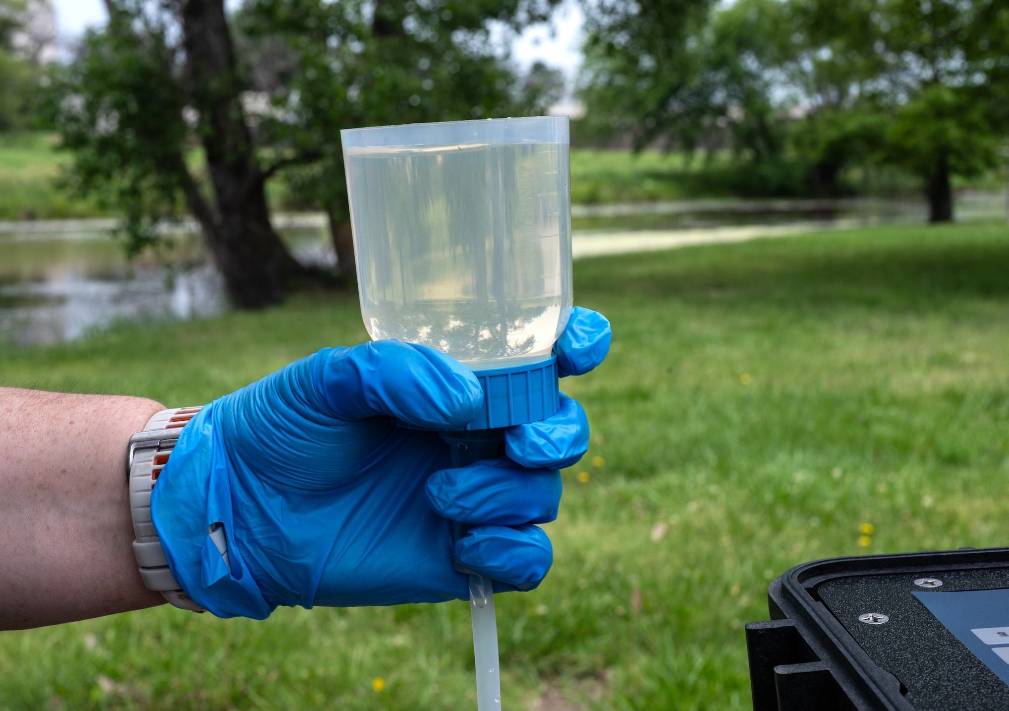 Natalie Wildrom, 22nd Civil Engineer Squadron, strains creek water through a filter membrane for an environmental DNA test for alligator snapping turtles June 11, 2025, at McConnell Air Force Base, Kansas. Testing the water for DNA is less invasive to the environment and wildlife than conducting a search for the snapping turtles. (U.S. Air Force photo by Staff Sgt. Tryphena Mayhugh)