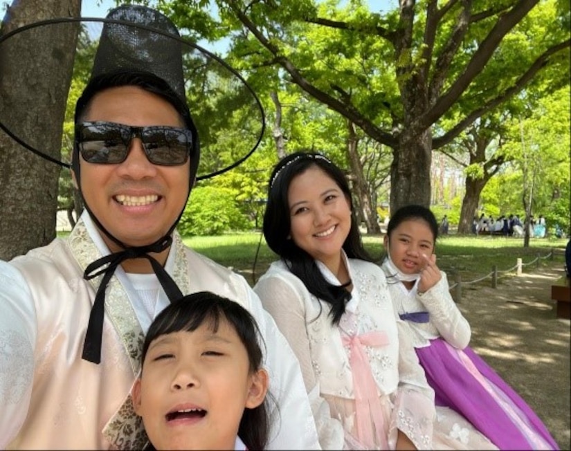 Man and family pose for a photo
