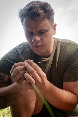 Hospitalman Matthew Gill, a Sailor assigned to the 2nd Marine Aircraft Wing’s Warrior Wellness and Readiness clinic, inspects an IV needle before inserting into a training aid during the Corpsman Cup held Friday, June 13 aboard Marine Corps Air Station Cherry Point.  The event tested the Corpsmen’s’ tactical medical skills, mental resilience and physical fitness through various stations.