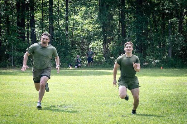 Hospital Corpsman Third Class Christopher Cusson, left, and Hospital Corpsman Second Class Jon Cericola, both assigned to 2nd Marine Aircraft Wing’s Warrior Wellness and Readiness Clinic, sprint during a shuttle run event as part of the Corpsman Cup held Friday, June 13 aboard Marine Corps Air Station Cherry Point.  The event tested the Corpsmen’s’ tactical medical skills, mental resilience and physical fitness through various stations.