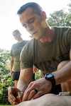 *Training* Lieutenant Commander Jacob Wittenauer, right, performs a chest decompression on a training manikin during the Corpsman Cup held Friday, June 13 aboard Marine Corps Air Station Cherry Point.  The event tested the Corpsmen’s’ tactical medical skills, mental resilience and physical fitness through various stations.  Wittenauer serves aboard Naval Health Clinic Cherry Point.