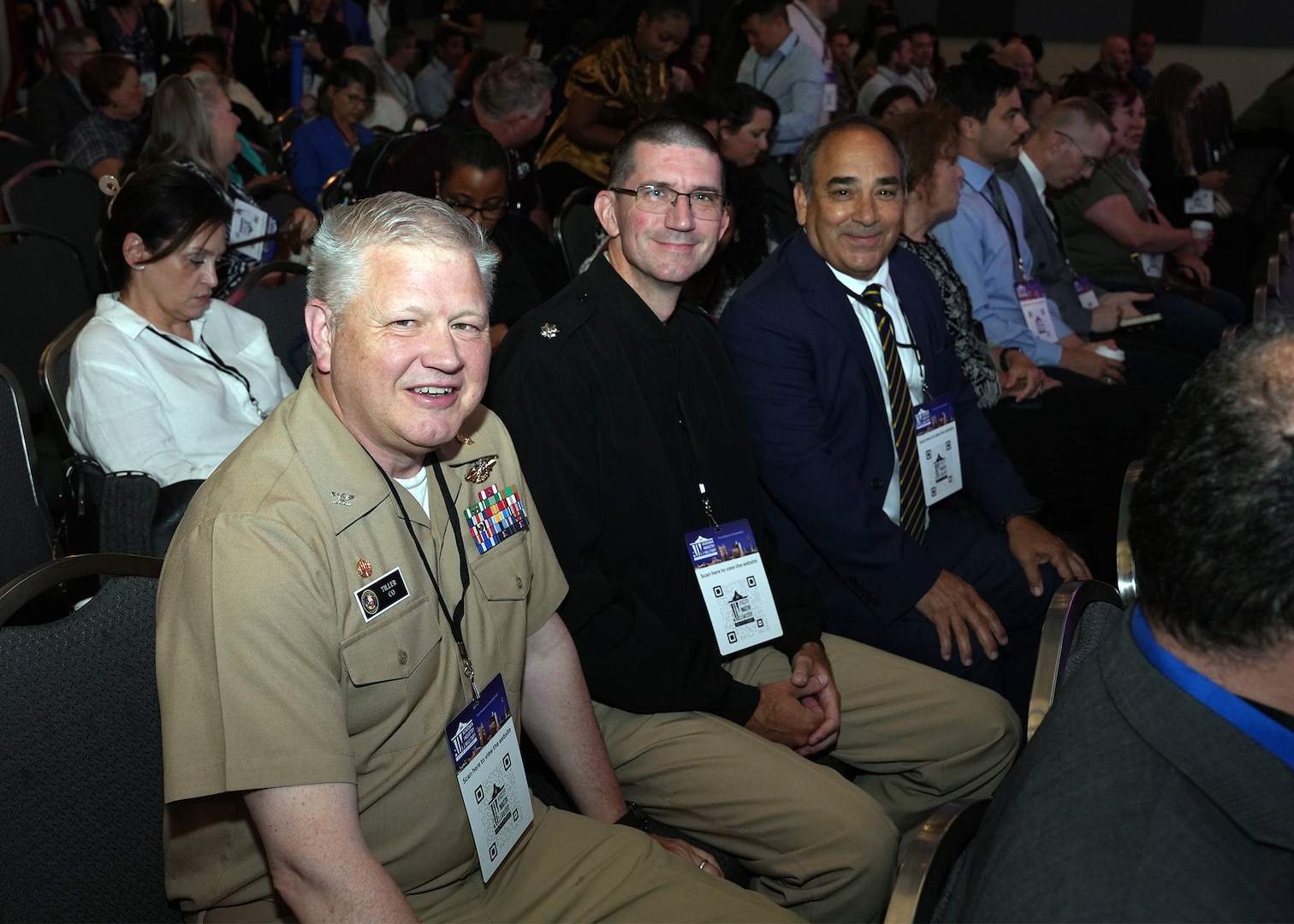 SAN ANTONIO – (June 16, 2025) – From left to right:  Naval Medical Research Unit (NAMRU) San Antonio’s Commanding Officer Captain Michael Tiller, Medical Corps, Executive Officer Cmdr. Nicholas Hamlin, Dental Corps, and Chief Science Director Dr. Darrin Frye attending the annual AIM Health R&D Summit held at the Henry B. Gonzalez Convention Center. Designed to promote cross-sector collaboration in the development of life-saving battlefield technologies, the one-day summit brings together top innovators from academia, industry, and the military to accelerate the research, development, and commercialization of transformative medical technologies. Collaborating and working alongside a wide range of research and development partners keeps Navy Medicine Research & Development (NMR&D) abreast of best practices and advances in medical knowledge. NAMRU San Antonio, part of NMR&D conducts gap-driven combat casualty care, craniofacial, and directed energy research in support of Navy, Marine Corps and joint U.S. warfighter health readiness and lethality while engaged in routine and expeditionary operations. (U.S. Navy photo by Burrell Parmer, NAMRU San Antonio Public Affairs/Released)