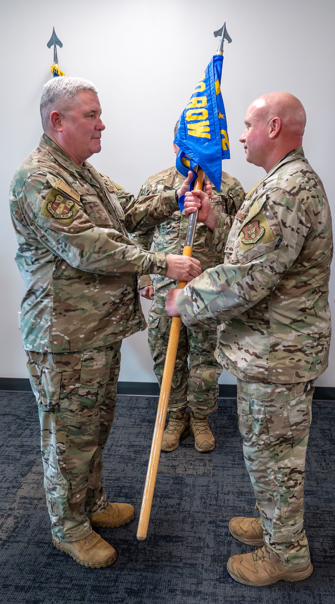 Lt. Col. John Lowe presents the 308th Rescue Squadron guidon to Lt. Col. Seth Davis.