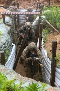 U.S. Army Soldiers assigned to Charlie Company, 1st Battalion, 125th Infantry Regiment, Michigan Army National Guard, tactically maneuver through a system of trenches during Exercise Baltic Viking near Alūksne, Latvia, June 8, 2025.