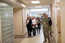 An Airman guides a tour group of civilian medical providers through Minot Air Force Base's military treatment facility.
