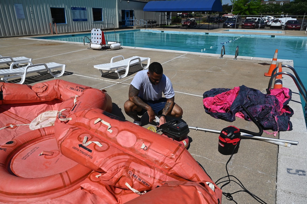 a person fills a raft with air.