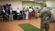 An Airman speaks to a tour group of civilian medical providers inside Minot Air Force Base's physical therapy center.