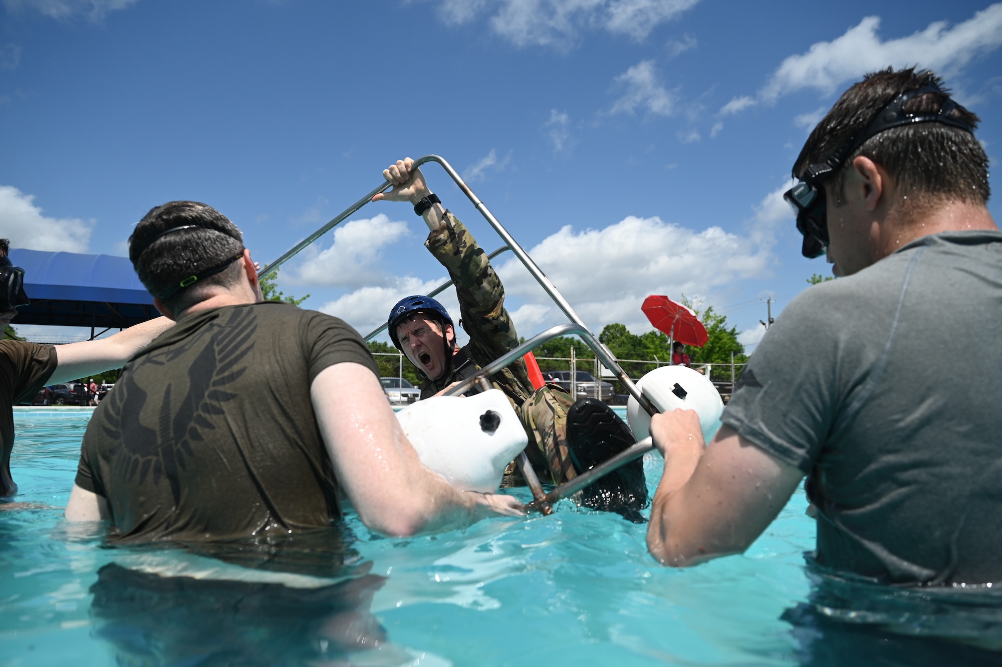 people flip a chair under water