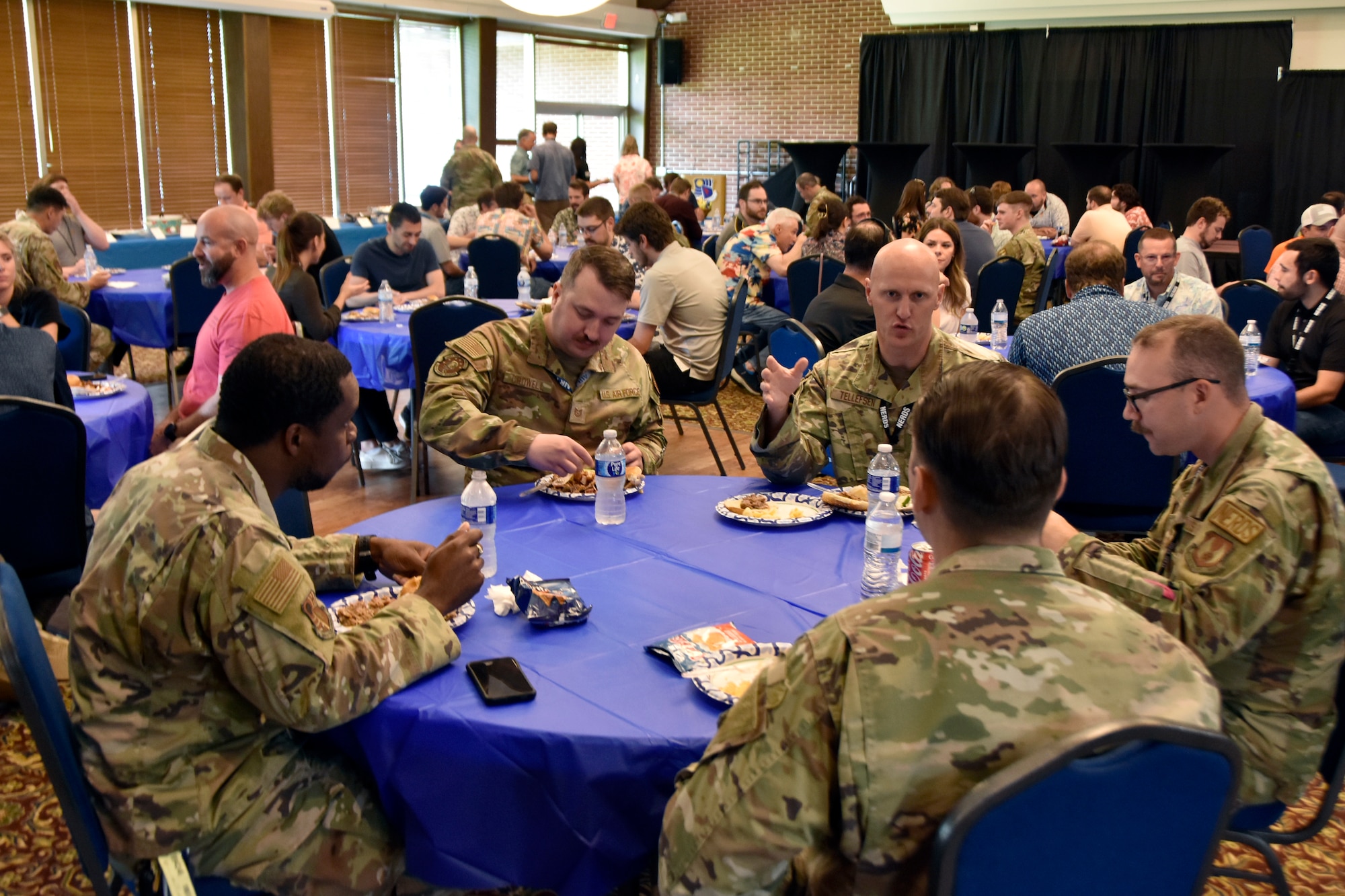 Airmen assigned to the 804th Test Group enjoy barbecue and sides prepared by fellow 804TG team members during the 804th Test Group BBQ Cookoff, June 6, 2025, at the Arnold Lakeside Complex on Arnold Air Force Base, Tenn. During the annual event, several members of the 804th Test Group team vie for the coveted large wooden fork, the trophy given to the cookoff victor, by preparing barbecue which is not only shared with colleagues across the test group, but also judged by several others on the 804TG team. (U.S. Air Force photo by Bradley Hicks)