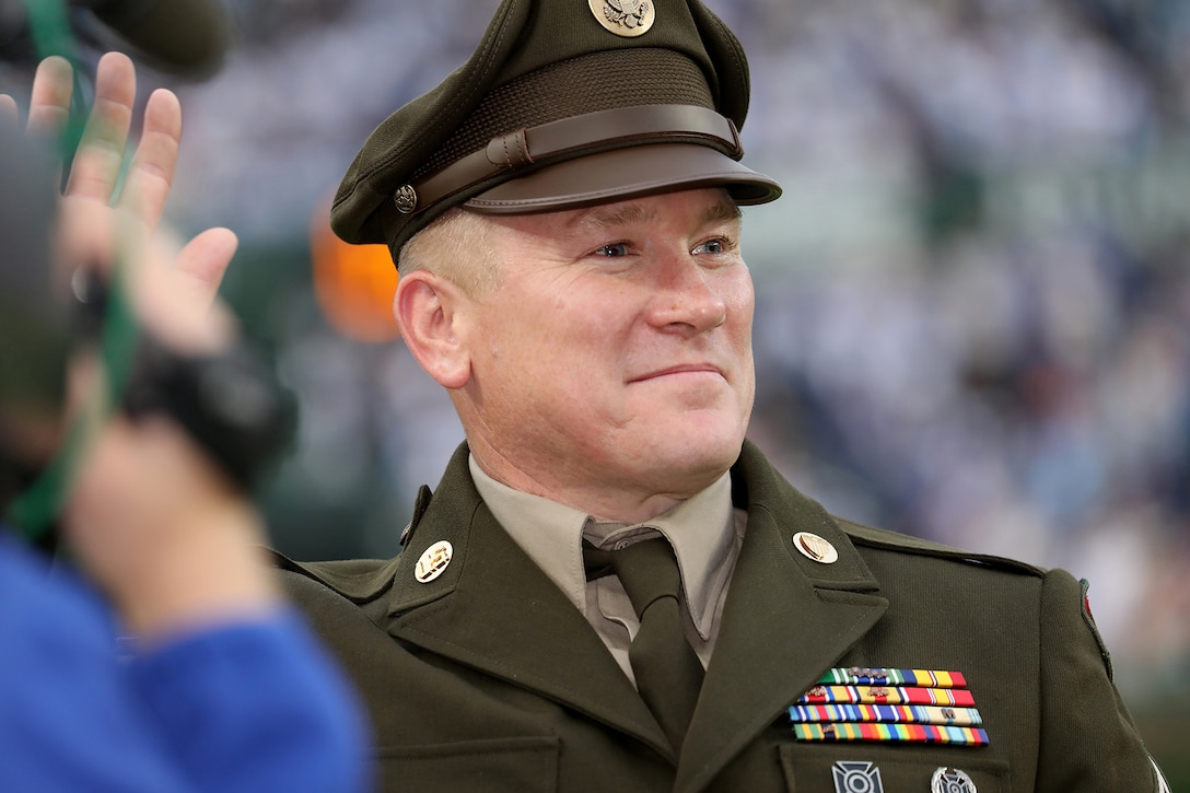 Sgt. 1st Class Robert Zalabak, 85th U.S. Army Reserve Support Command, receives an honor from cheering baseball fans at Wrigley Field during the Chicago Cubs on field military recognition, June 12, 2025.