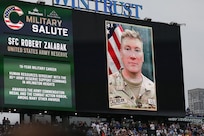 Sgt. 1st Class Robert Zalabak's photo appears on the Wrigley Field jumbotron during a Chicago Cubs Military Salute recognition, June 12, 2025.