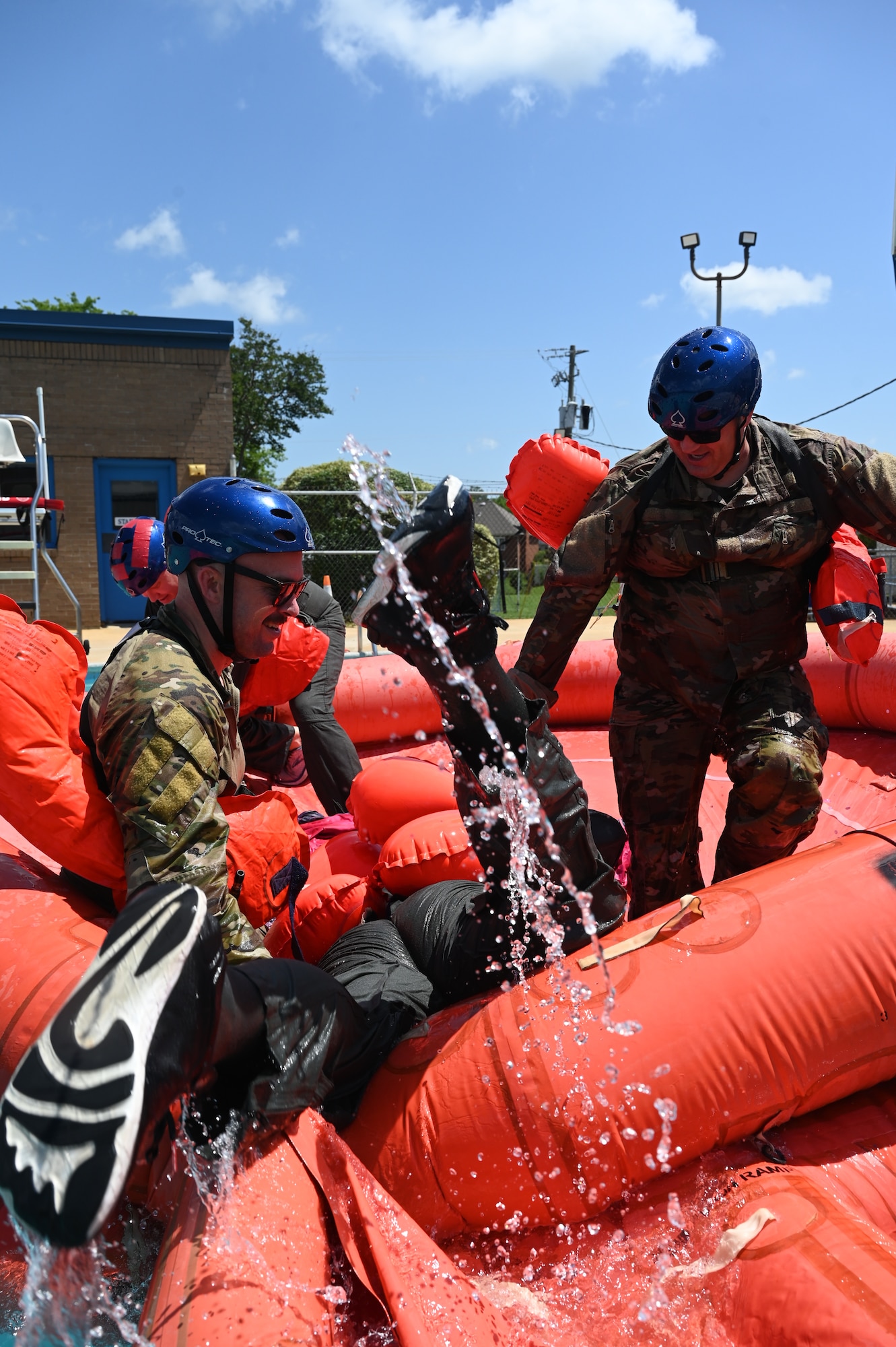 people help someone onto a life raft