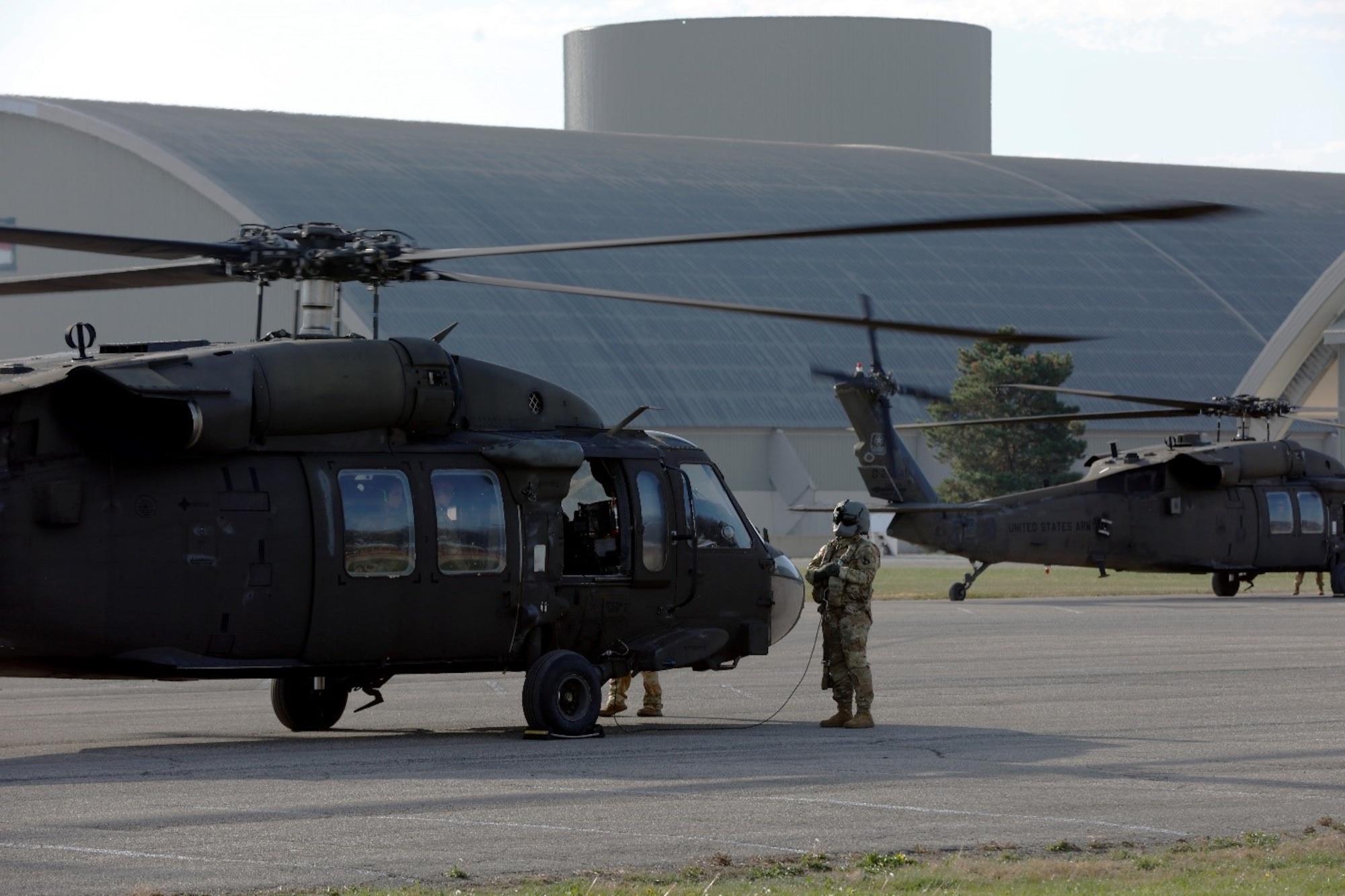 Two Black Hawk helicopters from the Kentucky National Guard in the parking lot in front of the National Museum of the U.S. Air Force.