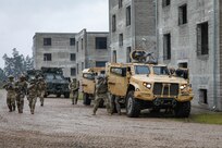U.S. Army soldiers assigned to Charlie Company, 1st Battalion, 64th Armored Regiment, 1st Armored Brigade Combat Team, 3rd Infantry Division, supporting Task Force Iron, joined multinational soldiers from Poland, Lithuania, Romania, and Czechia for Exercise Brave Boar in Bemowo Piskie Training Area, Poland, May 17, 2025. During the exercise, U.S. soldiers conducted joint training with NATO multinational partners in a simulated urban environment. Task Force Iron's mission is to engage in multinational training and exercises across the continent to increase lethality, while strengthening partnerships with NATO allies and regional security partners. The task force provides combat-credible forces to V Corps, America’s only forward-deployed corps in Europe. (U.S. Army photo by Sgt. Trevor Wilson)