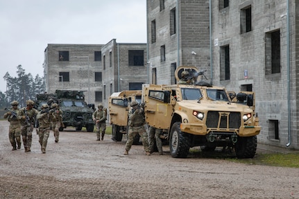 U.S. Army soldiers assigned to Charlie Company, 1st Battalion, 64th Armored Regiment, 1st Armored Brigade Combat Team, 3rd Infantry Division, supporting Task Force Iron, joined multinational soldiers from Poland, Lithuania, Romania, and Czechia for Exercise Brave Boar in Bemowo Piskie Training Area, Poland, May 17, 2025. During the exercise, U.S. soldiers conducted joint training with NATO multinational partners in a simulated urban environment. Task Force Iron's mission is to engage in multinational training and exercises across the continent to increase lethality, while strengthening partnerships with NATO allies and regional security partners. The task force provides combat-credible forces to V Corps, America’s only forward-deployed corps in Europe. (U.S. Army photo by Sgt. Trevor Wilson)