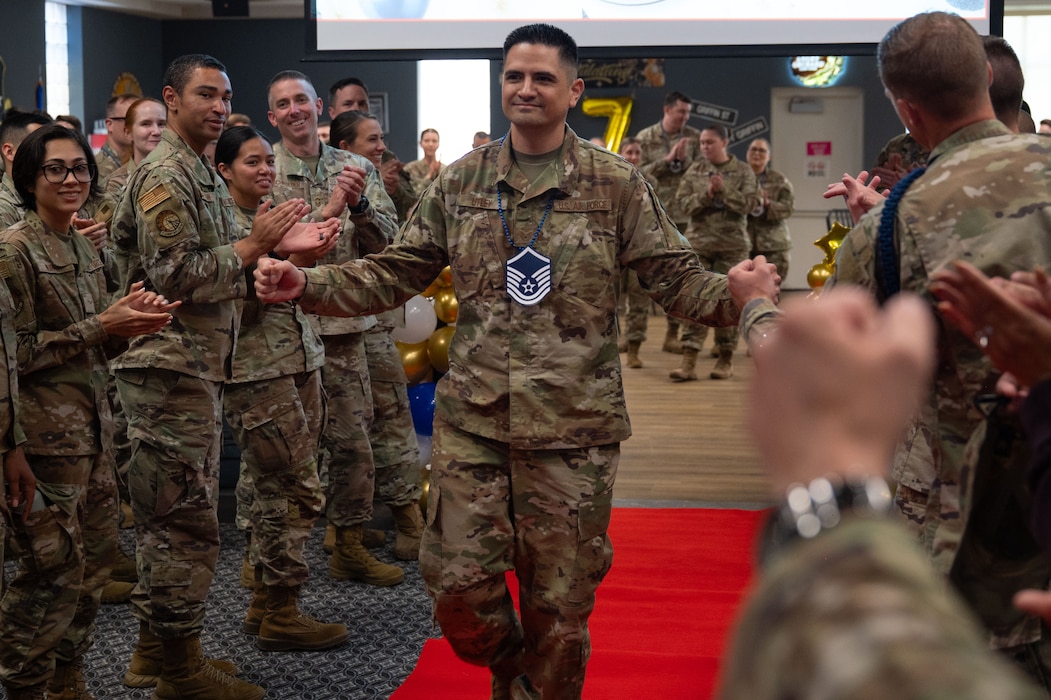 U.S. Air Force Master Sgt. select Jeremy Utley, 313th Training Squadron instructor, walks through the “Gauntlet” during the Master Sergeant Release Party at the Powell Event Center, Goodfellow Air Force Base, Texas, June 16, 2025. Goodfellow held the release party to celebrate the master sergeant selects while giving fellow wingmen and friends an opportunity to congratulate them on their success. (U.S. Air Force photo by Airman 1st Class Brian Lummus)