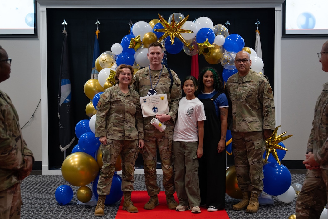 U.S. Air Force Tech. Sgt. Mathew Brown, 315th Training Squadron military training leader, receives his Master Sgt. select certificate from Col. Angelina Maguinness, 17th Training Wing commander, and Chief Master Sgt. Jason Ramon, 17th Mission Support Group senior enlisted leader, during the Master Sergeant Release Party at the Powell Event Center, Goodfellow Air Force Base, Texas, June 16, 2025. Master sergeants serve as leaders and mentors to junior Airmen and non-commissioned officers, sharing the lessons they've learned throughout their careers. (U.S. Air Force photo by Airman 1st Class Brian Lummus)