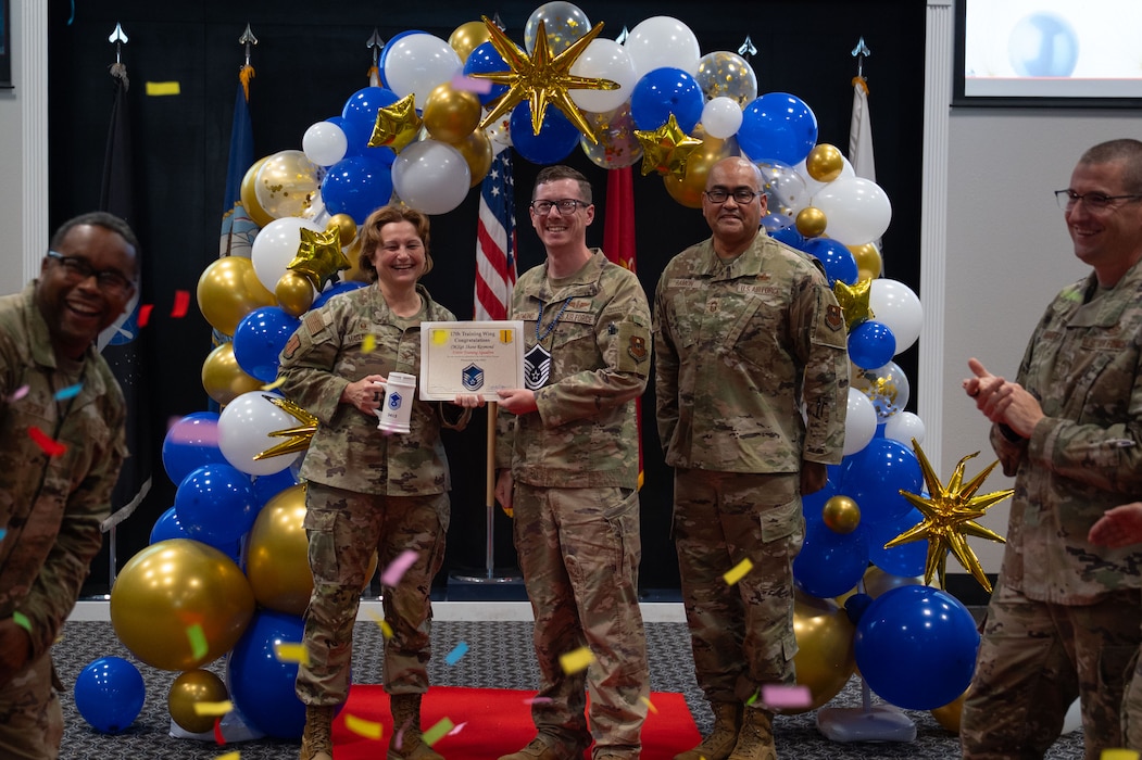 U.S. Air Force Master Sgt. select Shane Raymond, 316th Training Squadron section chief, receives his Master Sgt. select certificate from Col. Angelina Maguinness, 17th Training Wing commander, and Chief Master Sgt. Jason Ramon, 17th Mission Support Group senior enlisted leader, during the Master Sergeant Release Party at the Powell Event Center, Goodfellow Air Force Base, Texas, June 16, 2025. Maguinness congratulated the future master sergeants on their accomplishments and offered advice to prepare them for their future roles as senior non-commissioned officers. (U.S. Air Force photo by Airman 1st Class Brian Lummus)