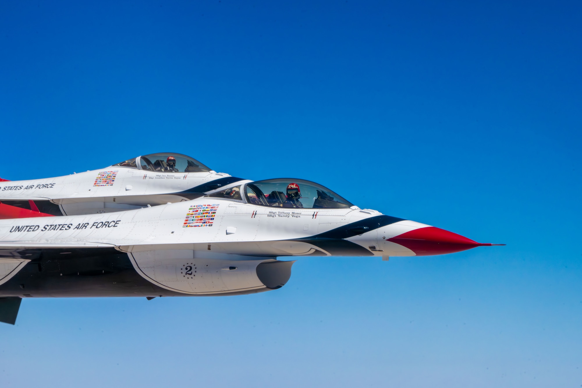 Two U.S. Air Force Air Demonstration Squadron "Thunderbirds" wait to be refueled by a KC-46A Pegasus assigned to McConnell Air Force Base, Kansas, over the U.S., June 13, 2025. The KC-46 crew offloaded approximately 75,000 pounds of fuel to the Thunderbirds. (U.S. Air Force photo by Airman 1st Class Paula Arce)