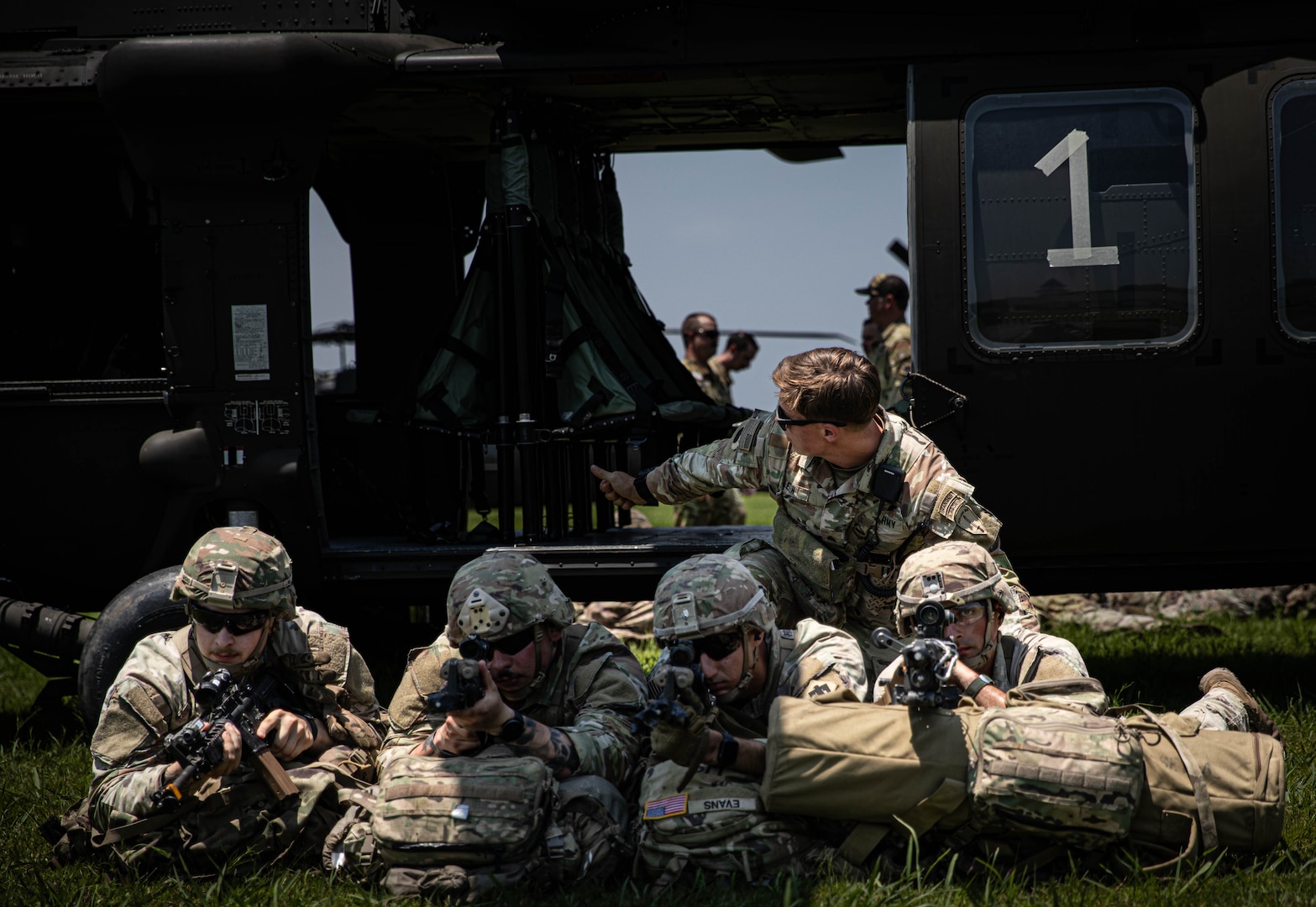 Sgt. Daniel Leikin, a ranger instructor assigned to the Army National Guard Warrior Training Battalion, signals to a UH-60 Black Hawk helicopter pilot during an air insertion as part of Light Leaders Course on June 10, 2025 at Camp Gruber Training Center, Oklahoma. Light Leaders Course is an intensive, leadership development program designed to sharpen small unit tactics and develop agile, adaptable and deployment-ready combat leaders. (Oklahoma National Guard photo by Spc. Cambrie Cannon)