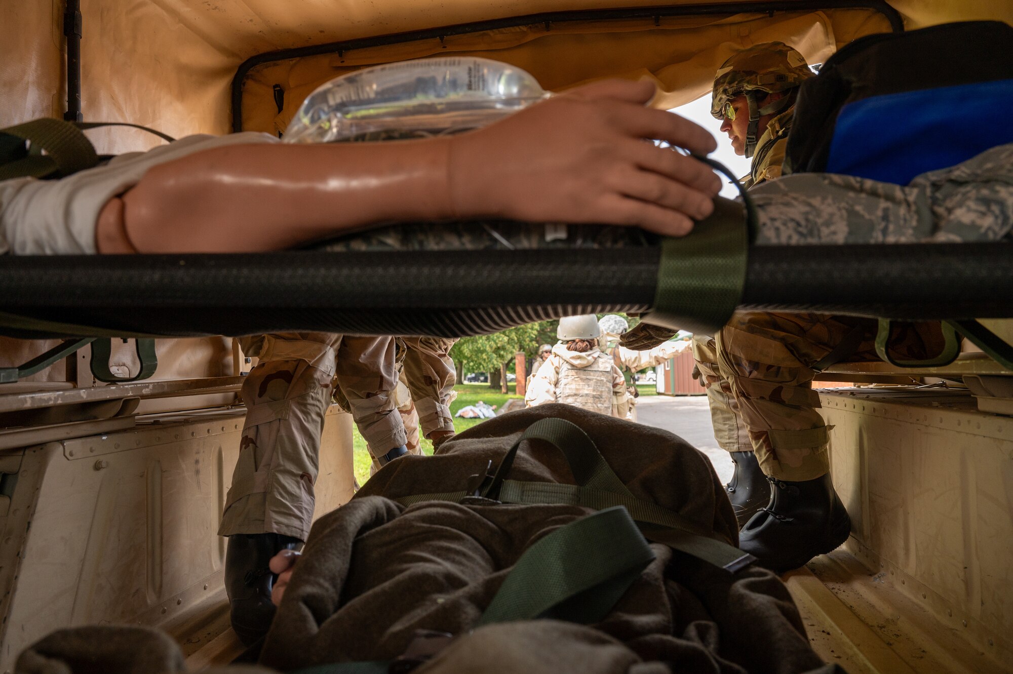 Airmen are inside the back of the vehicle simulating a medical evacuation