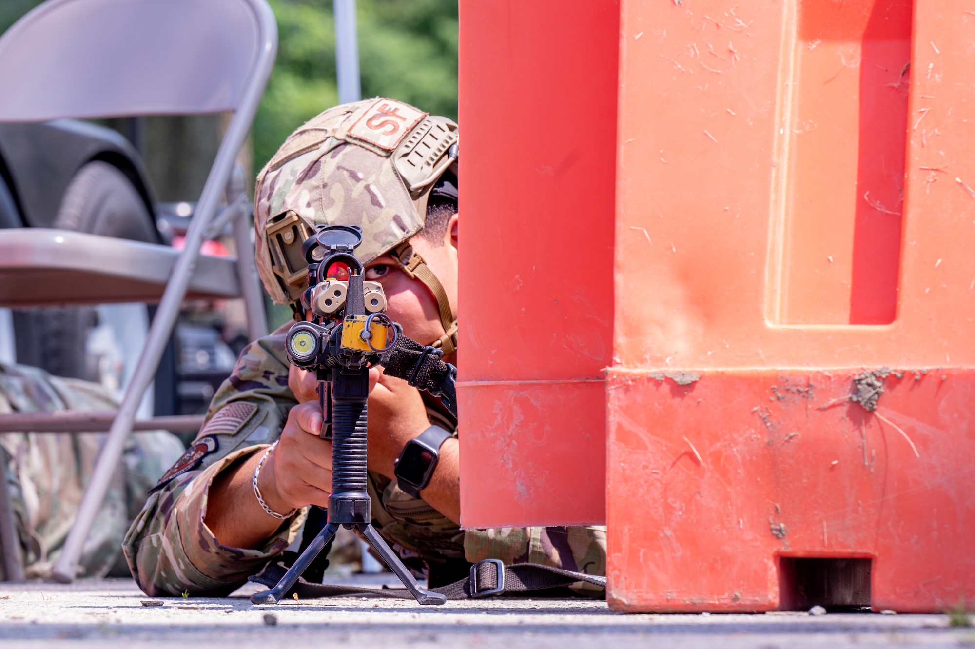 Fletcher maintains visual security from a prone firing position.
