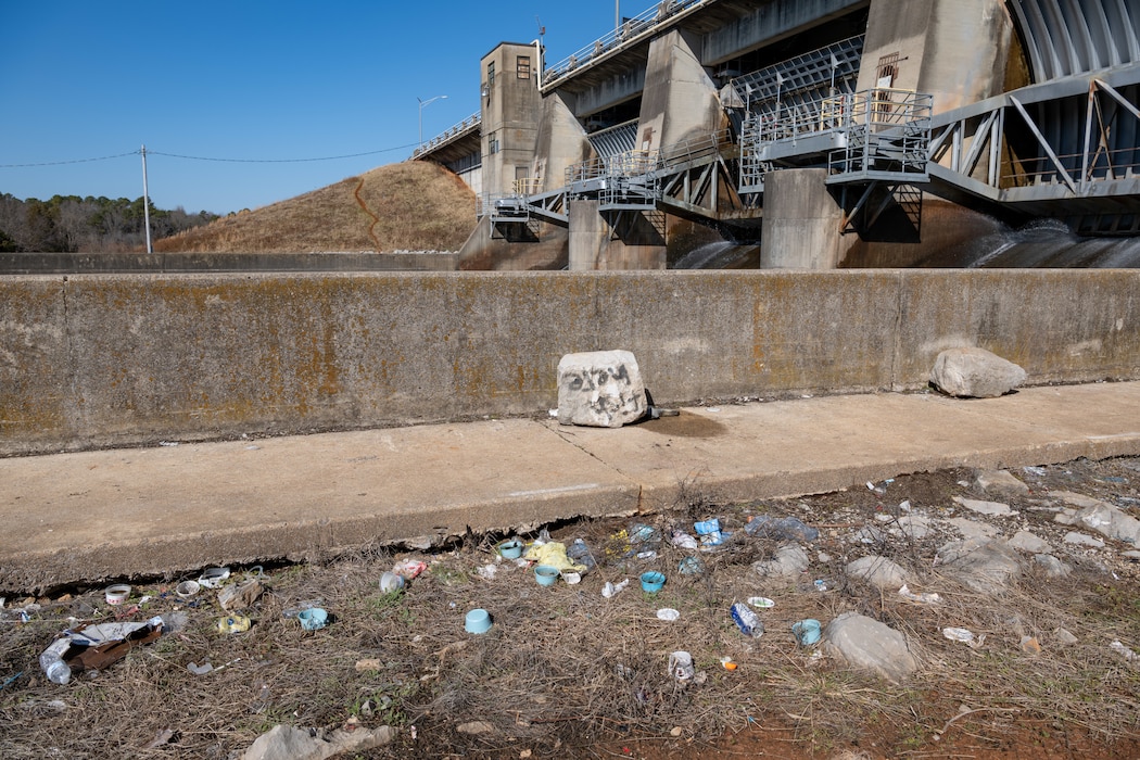 Trash is found scattered along a training wall of the Elk River Dam on Arnold Air Force Base, Tenn., January 28, 2025. Work is set to soon begin to prevent public access to the dam structure through the installation of security fencing around the downstream training walls. The effort is to ensure property security and safety in the area. The river will still be accessible to recreationalists for fishing and other activities. (U.S. Air Force photo by Keith Thornburgh)
