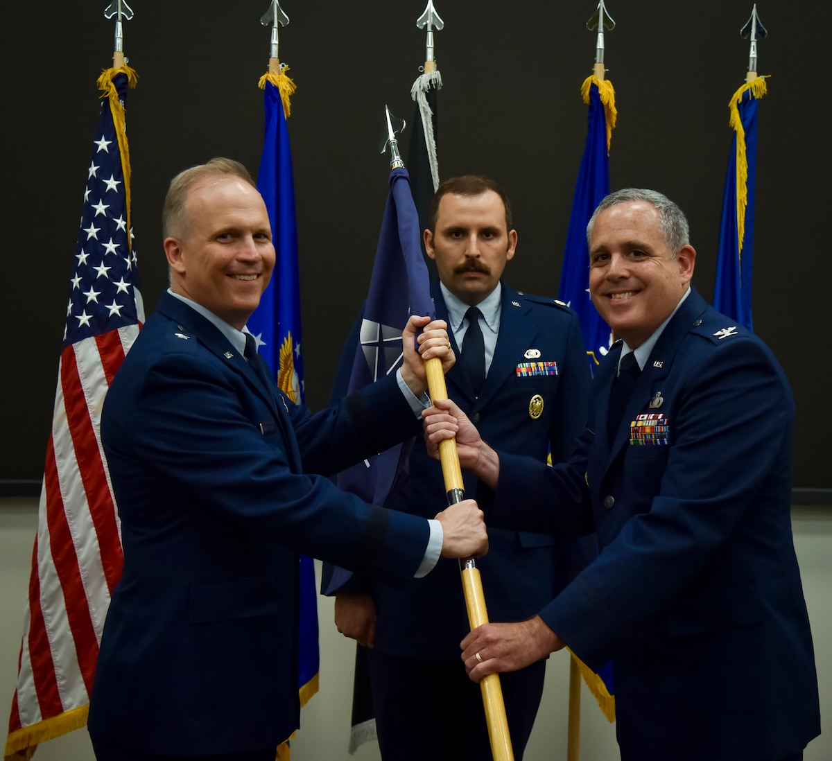 U.S. Air Force Brig. Gen. Jason Bartolomei, Air Force Research Laboratory commander and the Department of the Air Force’s technology executive officer, passes the guidon to Col. Nathan Stuckey during the AFWERX change of leadership ceremony at Wright-Patterson Air Force Base, Ohio, June 17, 2025.