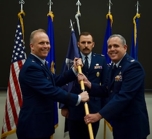 U.S. Air Force Brig. Gen. Jason Bartolomei, Air Force Research Laboratory commander and the Department of the Air Force’s technology executive officer, passes the guidon to Col. Nathan Stuckey during the AFWERX change of leadership ceremony at Wright-Patterson Air Force Base, Ohio, June 17, 2025.