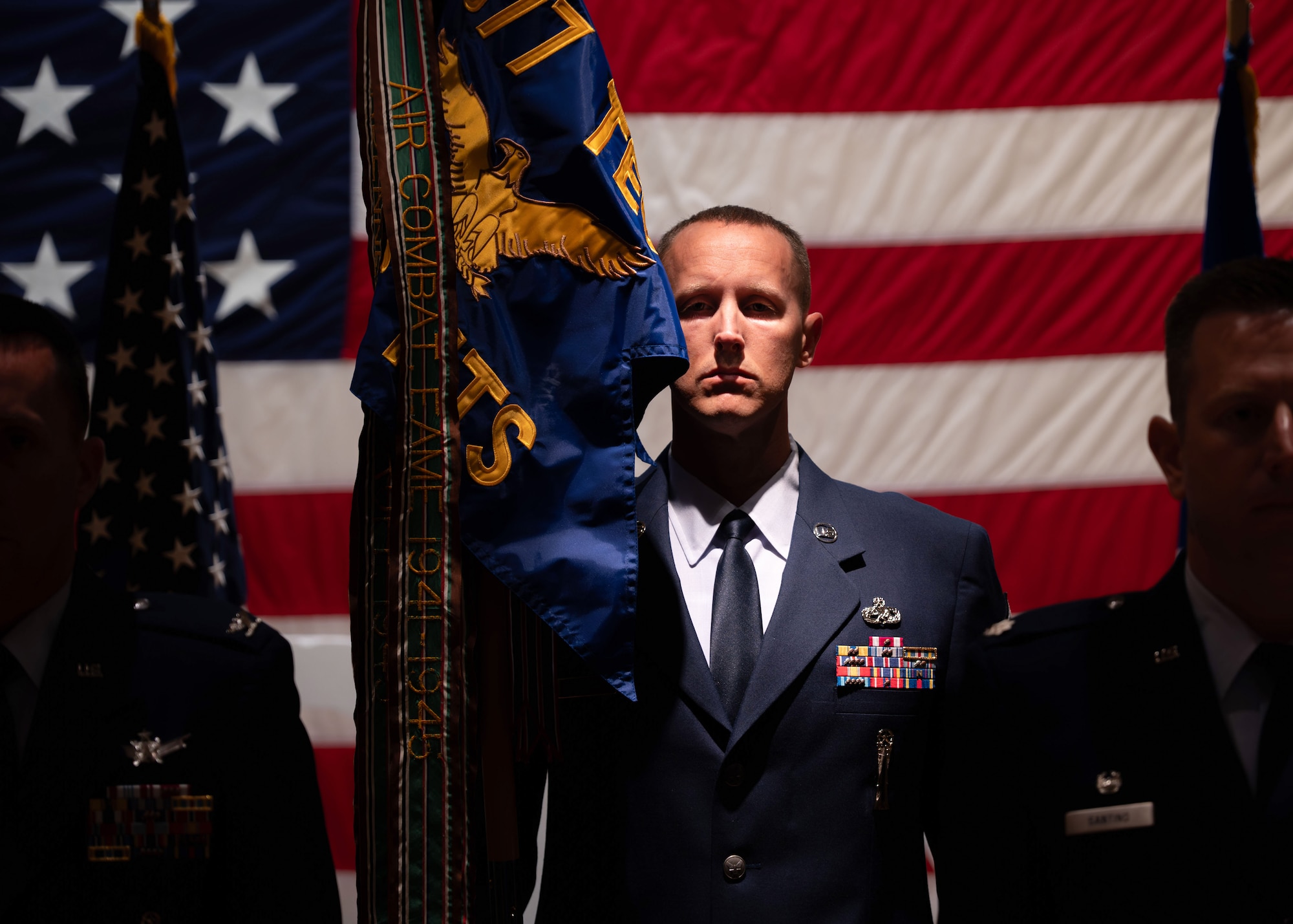 U.S. Air Force Senior Master Sgt. Sonny Putman, incoming 576th Flight Test Squadron senior enlisted leader, stands at attention with the guidon during the 576 FLTS change of command ceremony at Vandenberg Space Force Base, Calif., June 17, 2025. U.S. Air Force Lt. Col. Anthony Santino relinquished command of the 576 FLTS to Lt. Col. Karrie Wray.