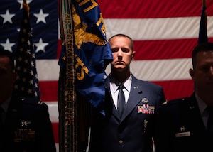 U.S. Air Force Senior Master Sgt. Sonny Putman, incoming 576th Flight Test Squadron senior enlisted leader, stands at attention with the guidon during the 576 FLTS change of command ceremony at Vandenberg Space Force Base, Calif., June 17, 2025. U.S. Air Force Lt. Col. Anthony Santino relinquished command of the 576 FLTS to Lt. Col. Karrie Wray.