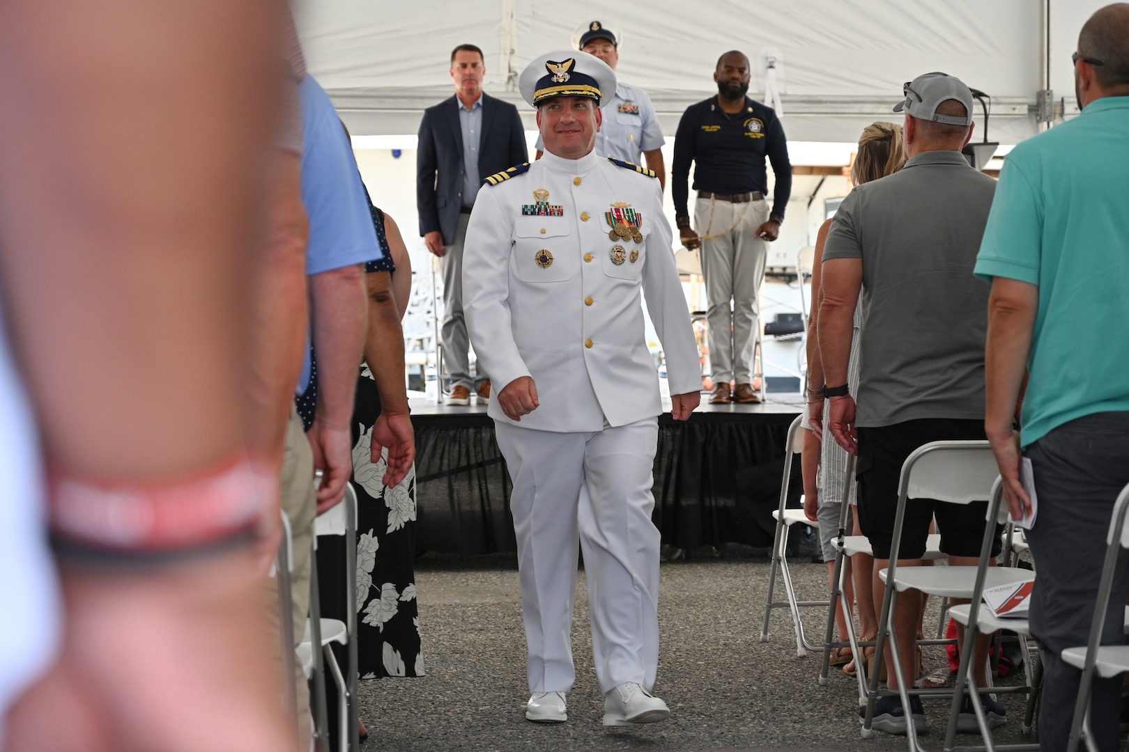 Cmdr. Matthew Press, commanding officer of Coast Guard Cutter Valiant (WMEC 621), departs the cutter's heritage recognition ceremony in Jacksonville, Florida, June 17, 2024. The cutter was honored after more than 57 years of service in front of Coast Guard and cutter leadership, the assembled crew and former crew members, family and friends. (U.S. Coast Guard photo by Petty Officer 2nd Class Brandon Hillard)