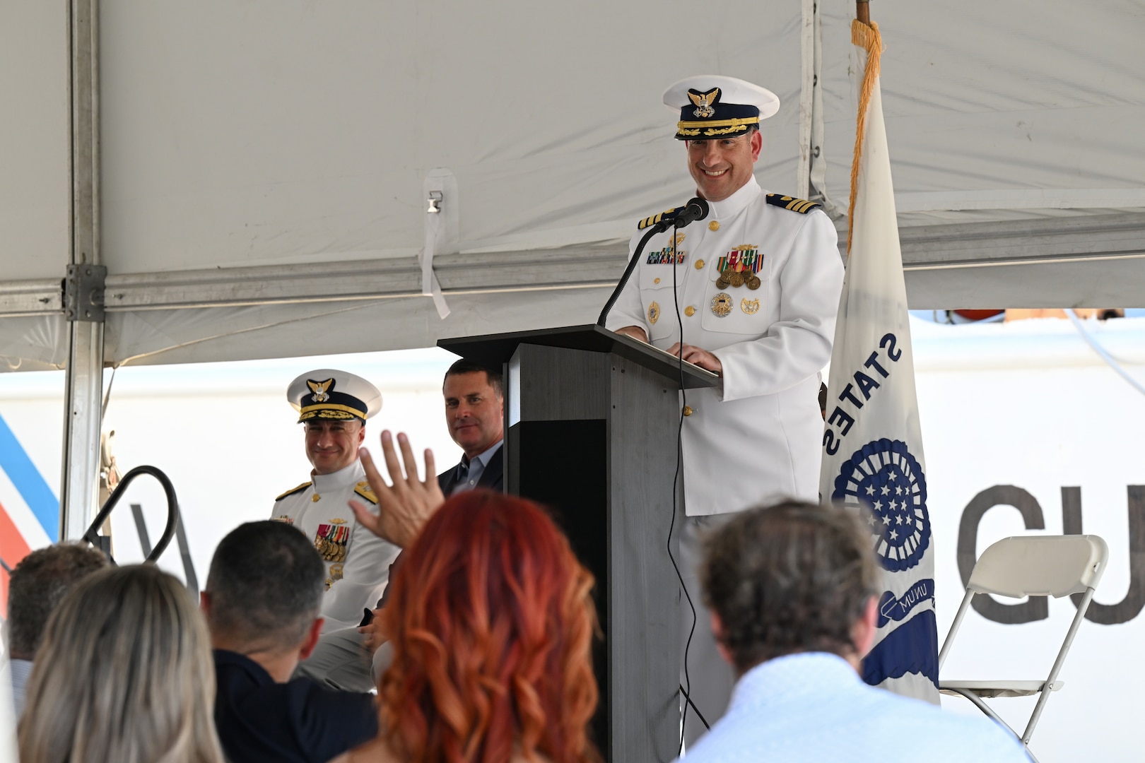 Cmdr. Matthew Press, commanding officer of Coast Guard Cutter Valiant (WMEC 621), engages with the audience during the cutter's heritage recognition ceremony in Jacksonville, Florida, June 17, 2024. The cutter was honored after more than 57 years of service in front of Coast Guard and cutter leadership, the assembled crew and former crew members, family and friends. (U.S. Coast Guard photo by Petty Officer 2nd Class Brandon Hillard)