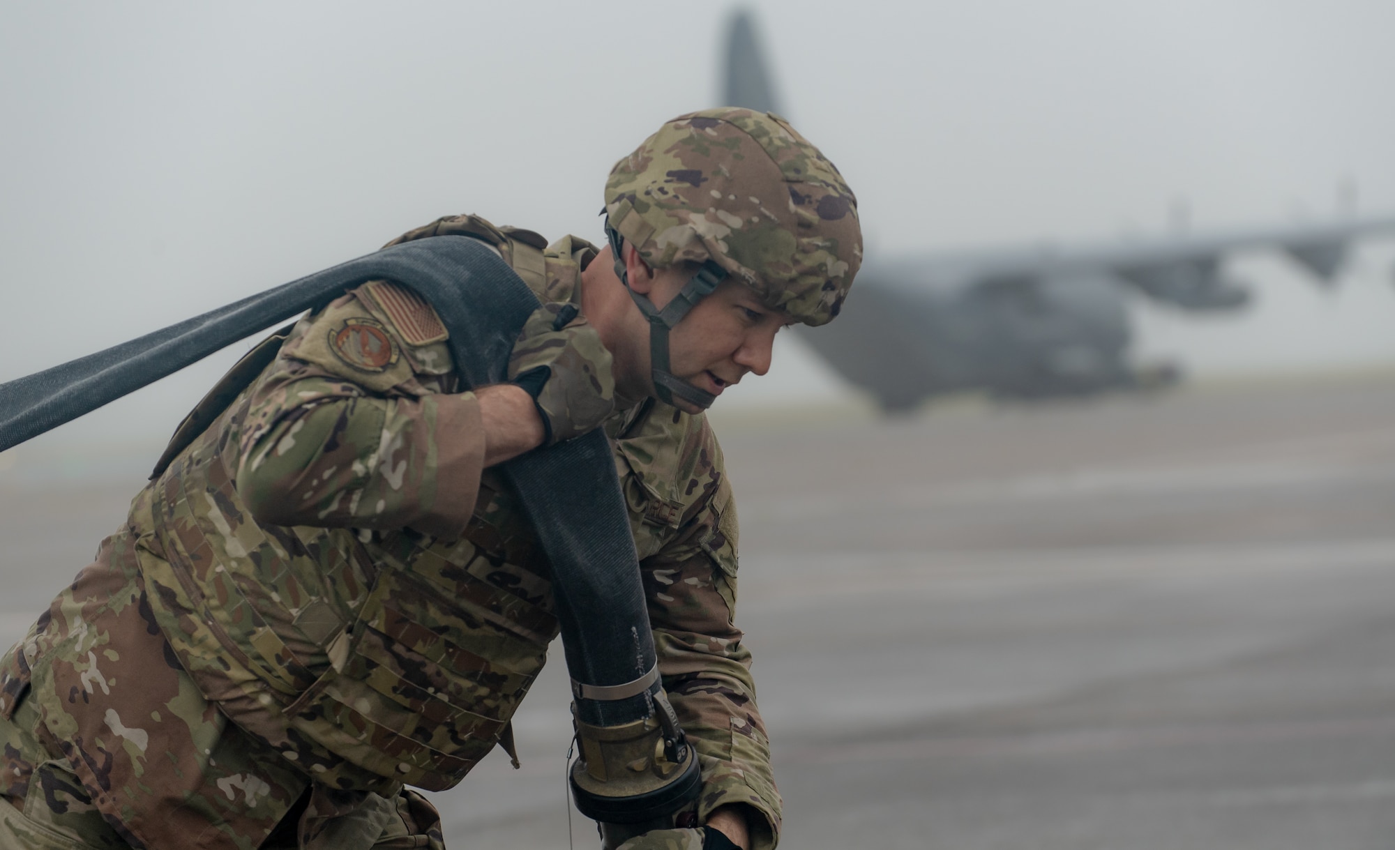 A special operations refueler here carries a hose during a Forward Arming and Refueling Point tryout at the 193rd Special Operations Wing June 17, 2025.