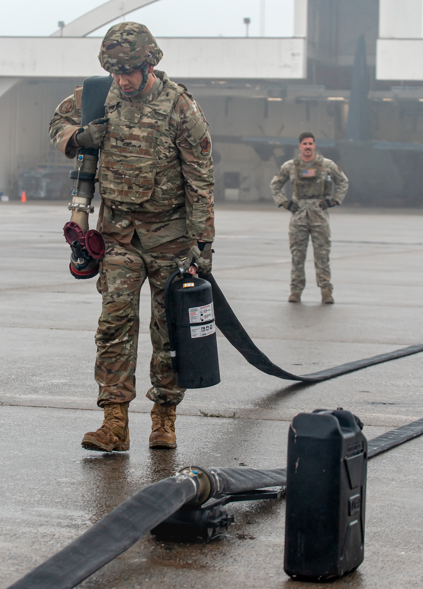 A special operations refueler here carries a hose and fire extinguisher during a Forward Arming and Refueling Point tryout at the 193rd Special Operations Wing June 17, 2025.