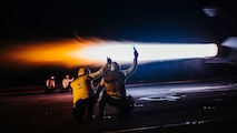 Sailors signal for an F/A-18F to launch off the flight deck of Nimitz-class aircraft carrier USS George Washington (CVN 73) while underway in the Philippine Sea, June 16, 2025.