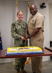 250617-N-IX644-1056 (June 17, 2025) FALLS CHURCH, Va. Hospital Corpsman 1st Class Rachel Bearden, left, the youngest hospital corpsman present, and Master Chief Hospital Corpsman Atiba Mathlin, the oldest hospital corpsman present, pose for a photo before cutting the birthday cake during a celebration for the 127th birthday of the Navy Medicine Hospital Corps at the Defense Health Headquarters, June 17. The Navy Hospital Corps is comprised of more than 26,000 active duty and reserve Hospital Corpsmen that are practicing or training in 40 technical specialties. Hospital Corpsmen are enlisted medical sailors who serve on the frontlines with our operators - whether embedded in Marine units, serving at MTFs, or aboard submarines and surface ships as Independent Duty Corpsmen. (U.S. Navy photo by Mass Communication Specialist 2nd Class Sasha Ambrose)